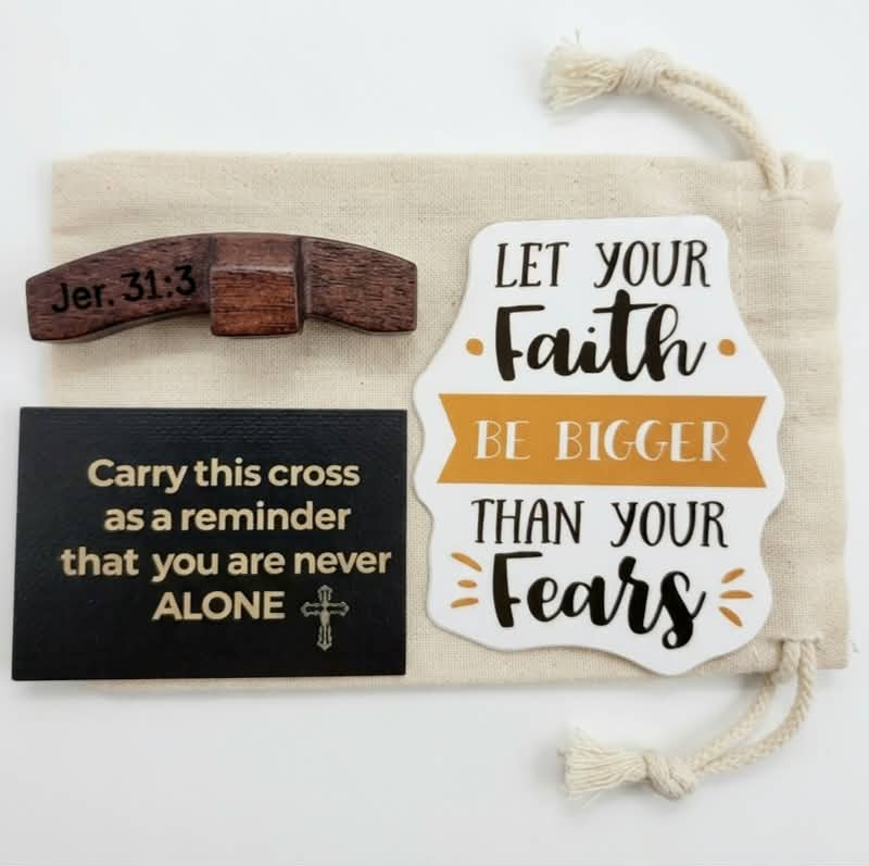 Faith blessing bag with wooden thumb cross engraved with Jer. 31:3, sentiment card, faith sticker, and natural linen drawstring bag